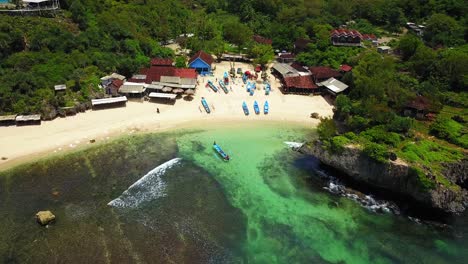 Aerial-shot-of-tropical-beach-with-traditional-fisherman-ship-on-the-village-with-ship-sailing