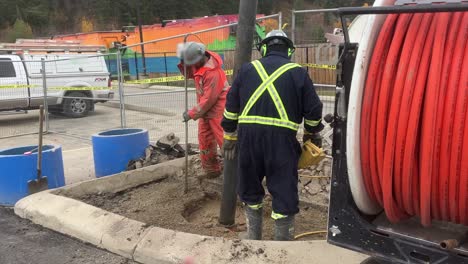 Construction-worker-assists-expert-crew-in-safely-exposing-underground-utility-lines-with-hydrovac-truck