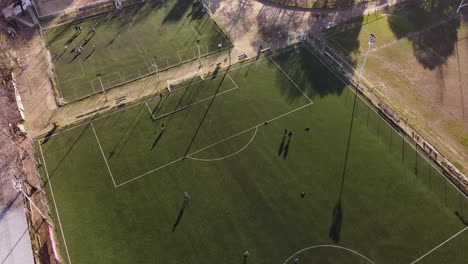 Football-players-train-to-score-goals-on-green-soccer-field-in-Argentina