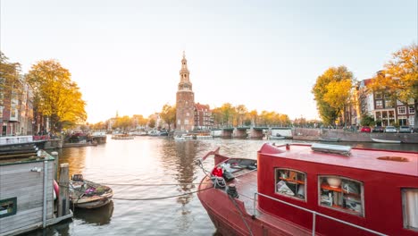 Dreamy-and-Moody-Wide-angle-Time-lapse-of-golden-hour-on-Amsterdam-Canal-with-house-boats-and-tower