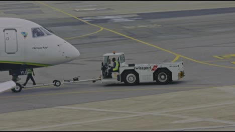 A-tug-master-vehicle-pushes-an-aircraft-away-from-the-departure-gate