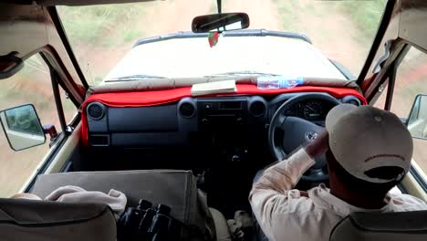 Tanzanian-safari-guide-driving-a-4x4-car,-interior-shot-with-the-dashboard
