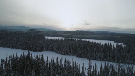 Ethereal-Winter-Landscape:-A-Scenic-Aerial-View-of-Snow-Covered-Spruce-Trees-Near-Latremouille-Lake-and-Little-Fort-Highway-24-on-a-Cloudy-DayFort-Highway-24-on-a-Cloudy-Day