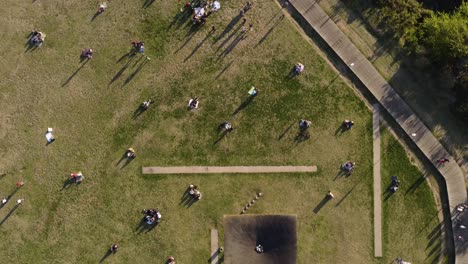 Aerial-top-down-circling-over-people-relaxing-at-public-park-at-coastal-area-of-Buenos-Aires