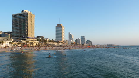 Tel-Aviv-Beach-Bathing-in-the-Evening-Light-in-Summertime,-Gentle-Pan