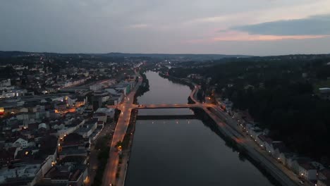 Aerial-of-Passau-German-city-at-night-with-sunset-citylights-and-river