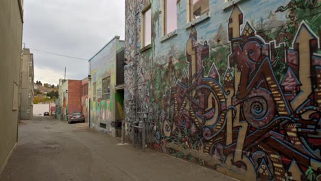 Graffiti-Artwork-in-the-Streets-of-Downtown-Kamloops,-pan-left-shot
