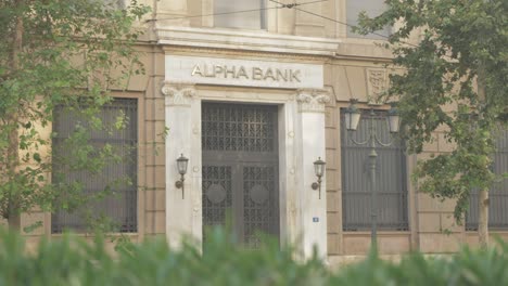 Traffic-passing-by-closed-entrance-of-Alpha-Bank-in-central-Athens