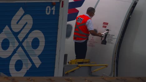 Ground-crew-shutting-the-door-of-a-passenger-aircraft-so-it-can-takeoff