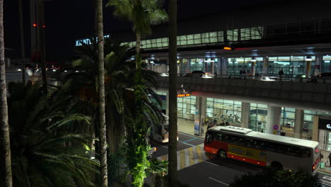 Shuttlebus-Navigating-At-The-Bus-Stop-Of-Jeju-International-Airport-At-Night