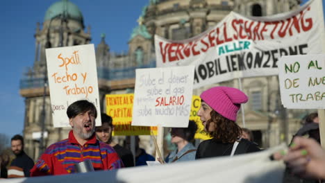 Latin-American-gathering-of-protesters-holding-banners-during-Berlin-economic-inflation-crisis-movement