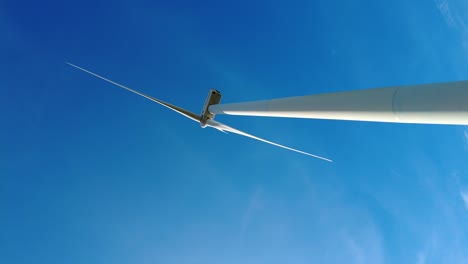 Portrait-clip-of-spinning-wind-turbine-with-blue-sky-background