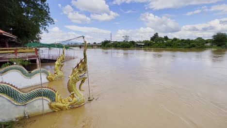 Naga-Dragons-On-Flooded-River-With-Brown-Muddy-Water-Flowing-In-Northern-Thailand