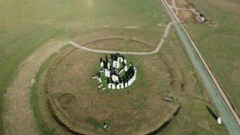 Stonehenge-famous-stone-circle-landmark-on-Amesbury-countryside-rising-aerial-view