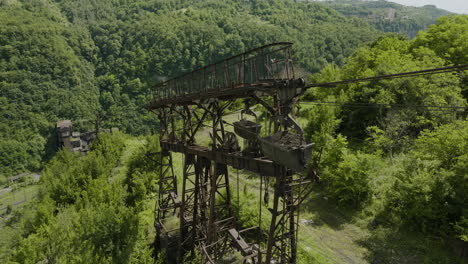 Rusty-weathered-freight-ropeway-pylon-above-factory-in-Chiatura-valley