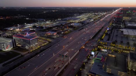 Aerial-view-overlooking-traffic-on-the-US-90-and-I-10,-dusk-in-Houston,-USA
