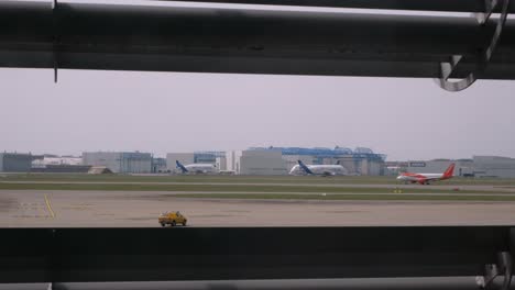 Vista-De-La-Fábrica-De-Airbus-En-Toulouse-Con-Un-Avión-De-Carga-Beluga-En-Movimiento,-Un-Airbus-319-De-Easyjet-Saliendo-Y-Un-Marshaller