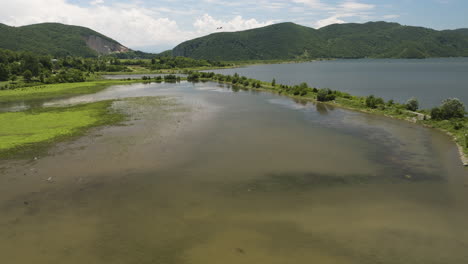 Grassy-causeways-with-crude-roads-in-Tkibuli-lake-reservoir,-Georgia
