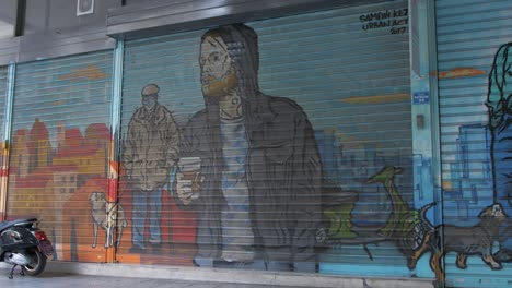 Spray-painted-mural-artwork-of-Athens-daily-life-on-shop-shuttering