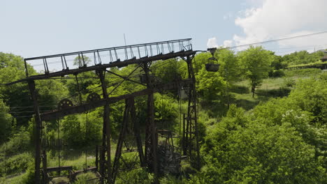 Rusty-freight-cargo-ropeway-pylon-on-overgrown-hillside-in-Georgia