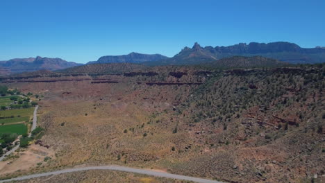 Drone-shot-of-a-vast-desert-mountain-range-Mount-Zion-National-Park-located-in-Southern-Utah