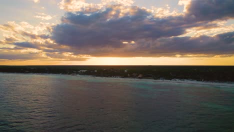 Aerial-view-of-the-sun-setting-over-Mexico's-coastline