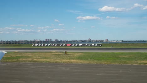 Welcome-to-New-York-sign-at-LaGuardia-Airport-with-view-to-East-River