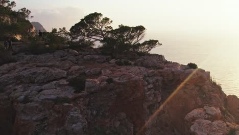 Drone-shot-solo-person-hiking-and-climbing-on-cliff-on-coast-of-Ibiza