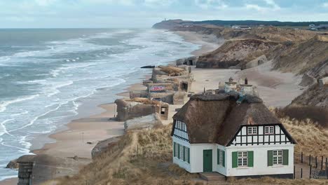 Danish-house-at-the-beach-with-bunkers-in-the-backround-shot-by-drone