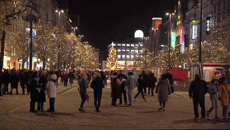 Decorated-Wenceslas-square-at-Christmas-with-crowds-of-people,-Prague