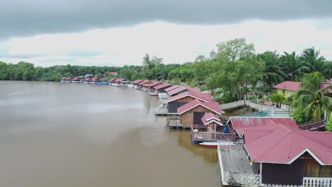 Drone-view-of-villa-near-river-in-Rompin-Pahang,-Malaysia