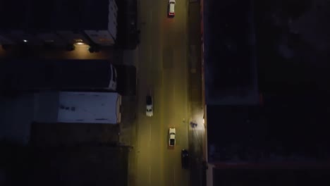 Aerial-view-following-cars-on-the-McKinney-street,-dusk-in-Houston,-USA---tilt,-drone-shot