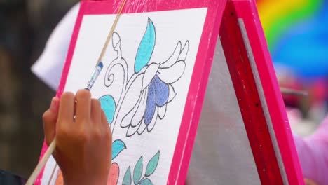 Slow-motion-shot-of-an-unknown-girl-coloring-a-picture-on-styrofoam