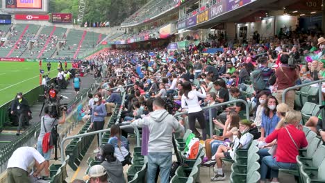Spectators-seated-in-the-stadium-as-they-attend-the-Hong-Kong-Seven-rugby-tournament,-one-the-city's-highest-profile-sport-events,-after-being-canceled-due-to-covid-19-government-restrictions