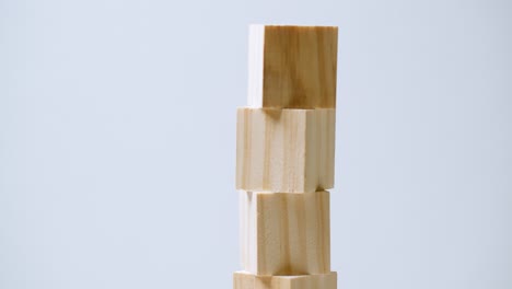 Small-wooden-cubes-stacked-on-a-rotating-surface