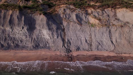 Static-drone-shot-of-cliffs-on-the-Jurassic-Coast-on-a-Summer-day,-Dorset,-UK
