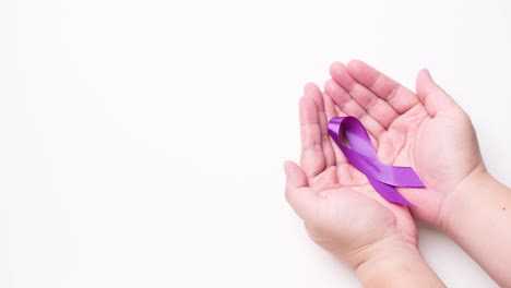 Male-hand-holding-ribbon-in-purple-color-on-white-background