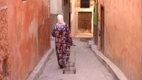 A-woman-walking-in-the-streets-of-Rabat,-Morocco