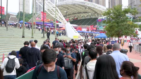 Chinese-attendees-queue-in-line-to-enter-the-stadium-holding-the-Hong-Kong-Seven-rugby-tournament,-one-of-the-city's-highest-profile-sporting-events,-after-being-canceled-due-to-covid-19-restrictions