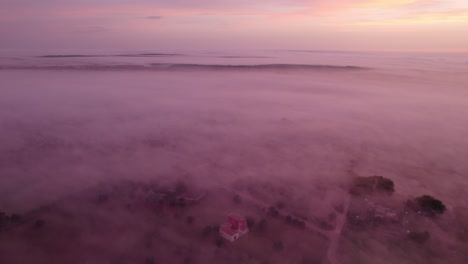 Puglia-province-covered-in-mist-during-stunning-colorful-sunrise,-aerial