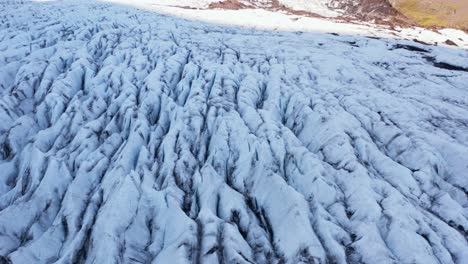 Aerial-view-of-icy-glacier-in-Iceland,-jagged-split-surface