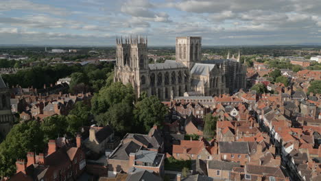 Aerial-Drone-Shot-of-Old-Iconic-Roman-British-City-Centre-York-with-Old-Buildings-and-Trees-Flying-Towards-Famous-York-Minster-Cathedral-North-Yorkshire-UK