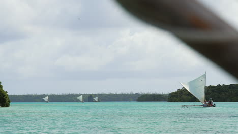 Looking-under-the-sail-on-an-outrigger-canoe-at-other-pirogue-sailing-at-Upi-Bay-on-the-Isle-of-Pines