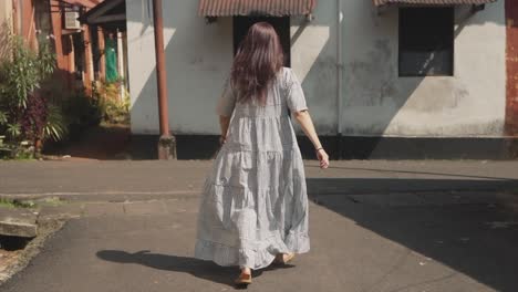 Mujer-India-Morena-Caminando-Frente-A-La-Cámara,-En-Las-Calles-Históricas-De-Fontainhas,-India,-En-Un-Día-Soleado