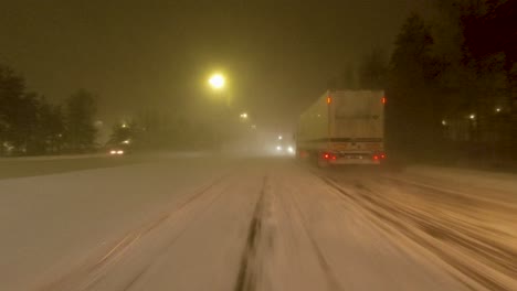 POV-driving-past-a-snow-plow-clearing-a-lane-on-a-highway-in-Helsinki