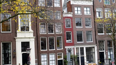 Wide-shot-of-smallest-narrow-house-in-Amsterdam-City-near-Canals-during-daytime