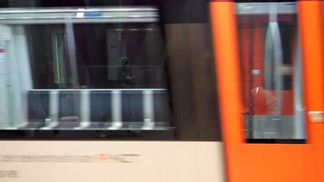 Slow-motion-of-metro-in-Amsterdam-arriving-at-train-station,-close-up
