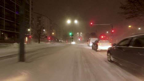 POV-shot-driving-through-traffic-lights-within-downtown-Helsinki-in-a-snowstorm