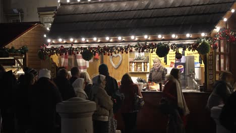 People-Queuing-To-Be-Served-At-Christmas-Market-Stall-In-Trafalgar-Square-At-Night-In-London