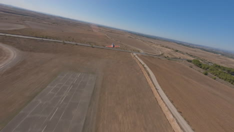 Aerial-tracking-shot-of-RC-plane-maneuvers-flying-on-sunny-day